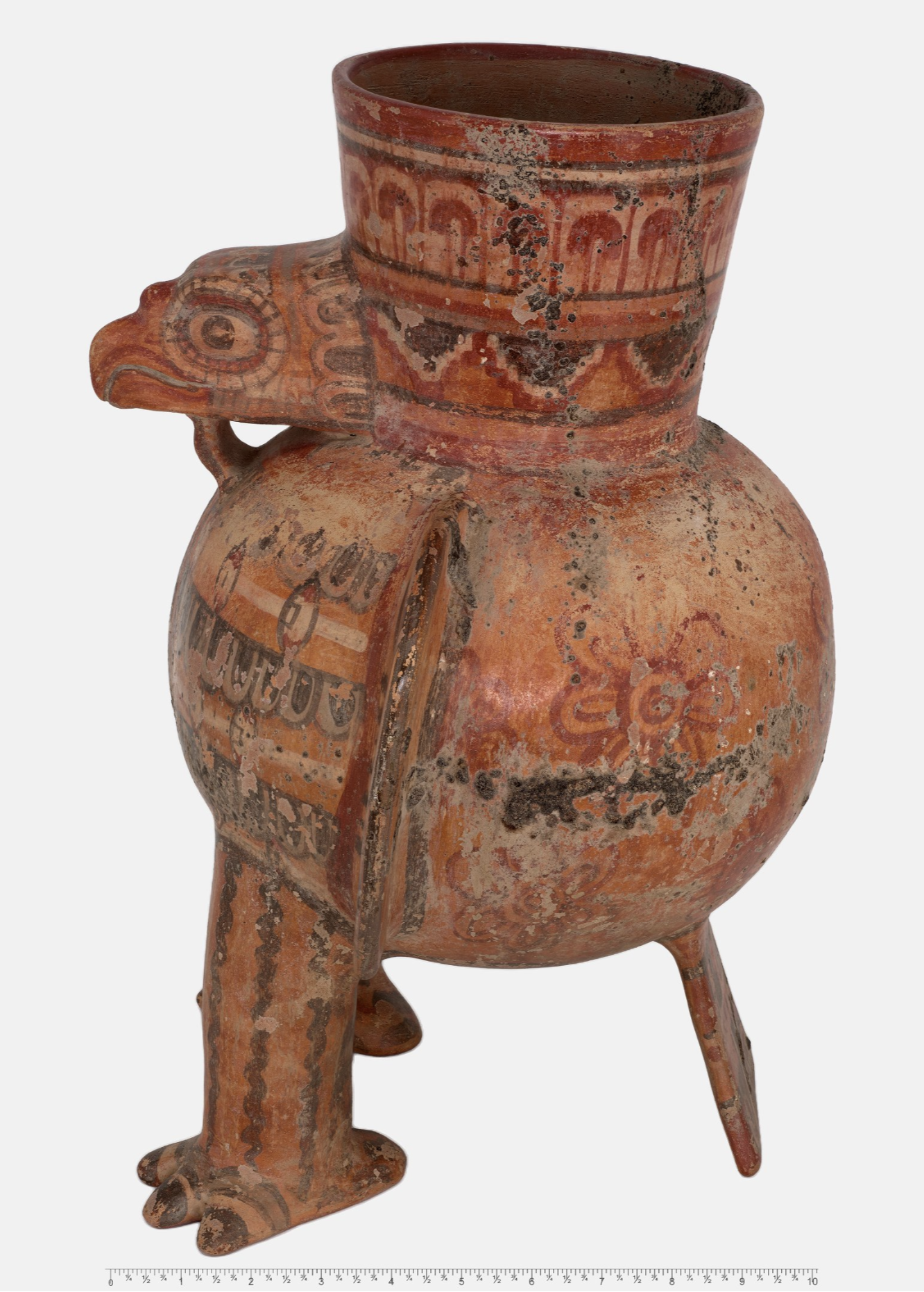 Side view of the same clay eagle pot, showing the bird's legs and flat tail.
