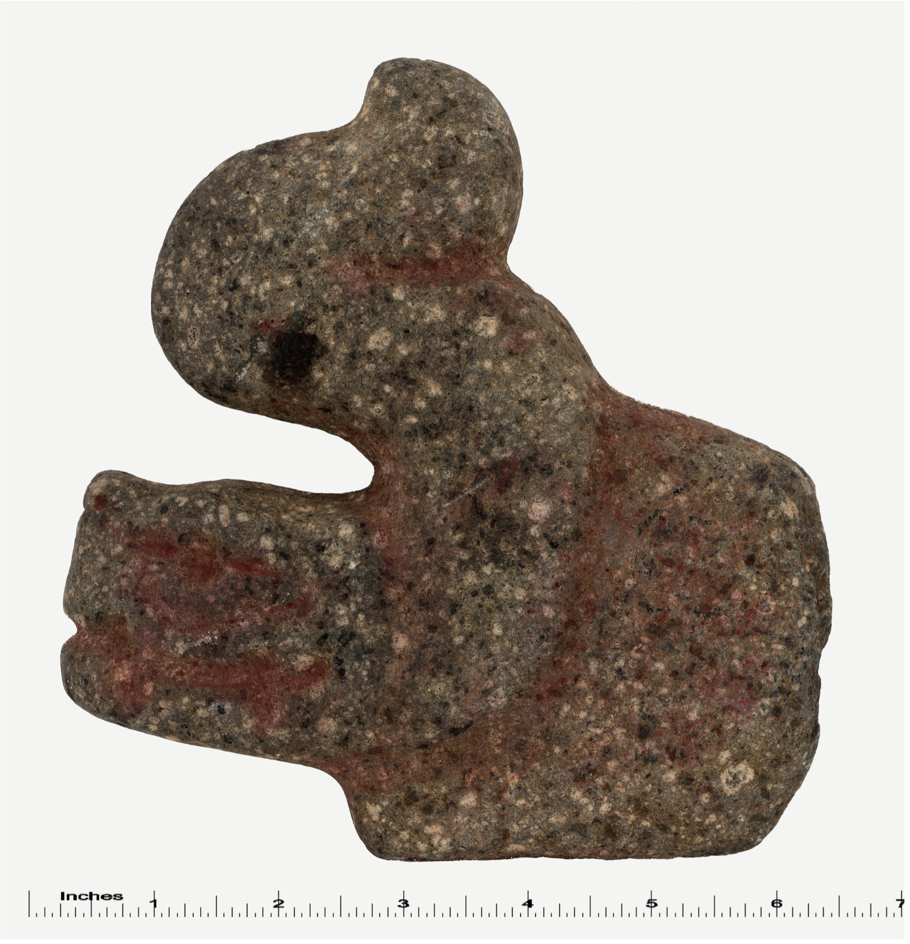 A carved stone hacha from the Maya with a serpent hidden in its shapes, shown from the front.